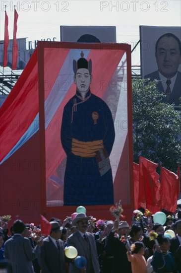 MONGOLIA, Ulan Bator, Nadam  Mongolian National Day. Parade of Communist Party members and workers carrying banners and posters of the first Mongolian President Sukhebator in foreground and other important Mongolian politburo members displayed in background. Ulaan Baatar East Asia Asian Baator Mongol Uls