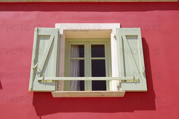 GREECE, Ionian Islands, Kefalonia, "Lixouri, Stil Tipaldou, Green and cream window and pink wall of house."