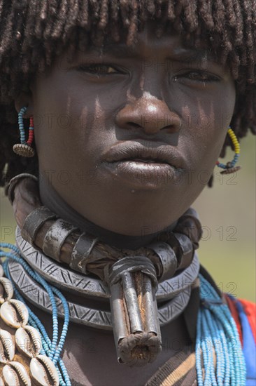 ETHIOPIA, Lower Omo Valley, Key Afir, Banner woman wearing a necklace know as a Bignere - an metal band with a phallic protuberance to signify that she is a first wife