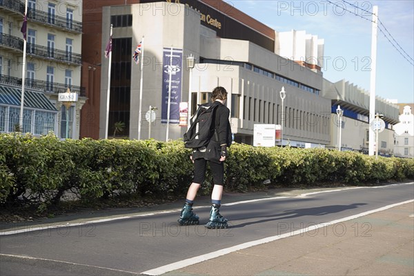 ENGLAND, East Sussex, Brighton, Rollerblading on the seafront promenade.