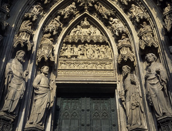 GERMANY, North Rhine Westphalia, Cologne, Cathedral doorway flanked by stone statues and decorative carvings