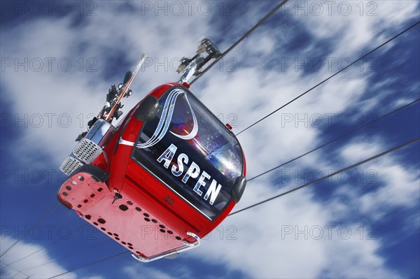 20091058 View cable car ski lift against blue sky with clouds. North America United States America White  WeatherTravelTransportDominant RedDominant WhiteDominant BlueRegion - North America Jon Hicks 20091058 USA Colorado Aspen