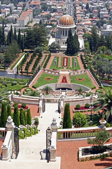 ISRAEL, Northern Coast, Haifa, "Zionism Avenue.  View of Baha'i Shrine and Gardens.  Tiered formal gardens with palms, cypress trees and central domed shrine with city part seen beyond."