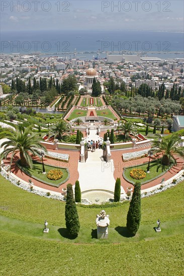 ISRAEL, Northern Coast, Haifa, "Zionism Avenue.  View of Baha'i Shrine and Gardens built as a memorial to the founder of the Baha’i faith.  Tiered, formal gardens, palms and cypress trees, central domed shrine and city and distant port beyond."