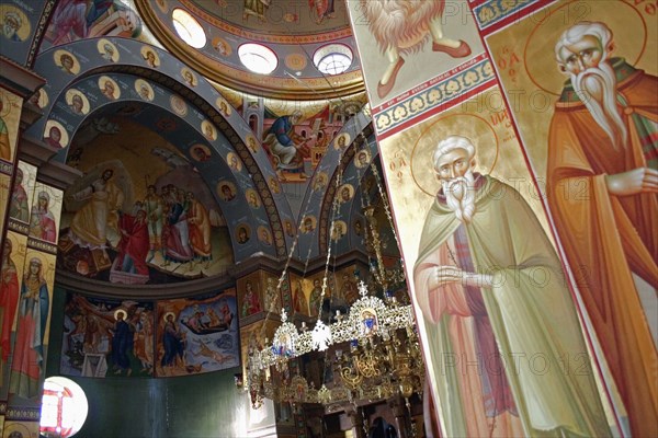 ISRAEL, Hazafon, Sea of Galilee, "Nazareth.  Interior of the Greek Orthodox Church of St. Gabriel also known as the Church of the Annunciation, part view of domed roof and archways decorated with paintings of biblical scenes and the saints, wall hangings and tiled mosaics.  Church is located over the spring that fed Marys Well."