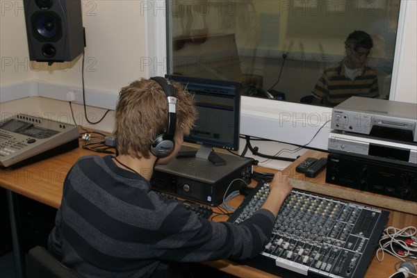 CHILDREN, Education, Secondary, Students using sound desk in school recording studio.