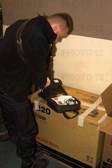 LAW and ORDER, Police, Drugs Raid, Police searching for drugs during a raid on a residential house.