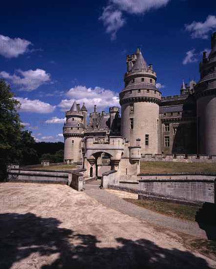 FRANCE, Picardie, Oise, "Chateau de Pierrefonds, dating from 14th C.  Restored  by Viollet-le-Duc from 1857 on the orders of Napoleon III.  Exterior with crenellated walls and turrets. Used as set for BBC Merlin series."