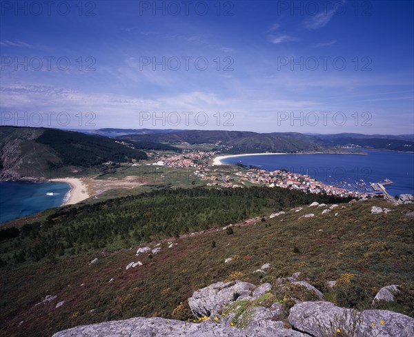 SPAIN, Galicia, View north from Cap Fisterra with Praia do Mar de Fora on the left and the village of Fisterra on the right.