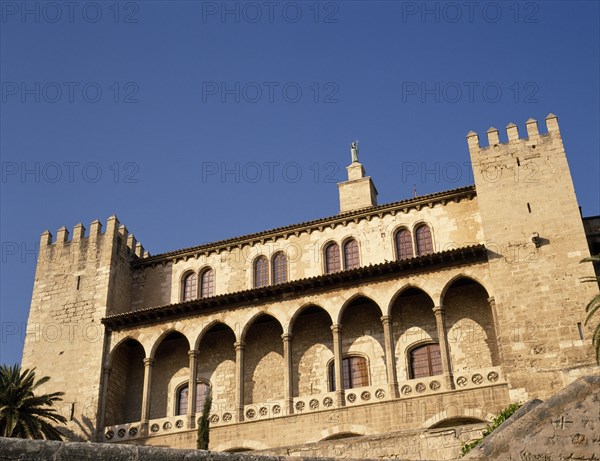 SPAIN, Balearic Islands, Mallorca, "Palma.  Palau de l’Almudaina, part view of exterior of Moorish palace with crenellated towers and arcaded balcony, now houses a museum."