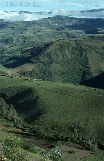 ECUADOR, Atahualpa, "Elevated view across tundra region with green hills, valleys and agricultural terracing."