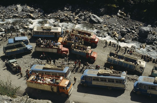 BOLIVIA, Yungas, "Road block on road to La Paz with view over buses, trucks and passengers at a standstill in road"