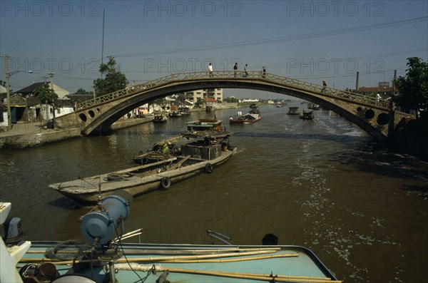 CHINA, Jiangsu Province, Transport, Barges travelling under bridge on the Grand Canal between Suzhou and Wuxi.