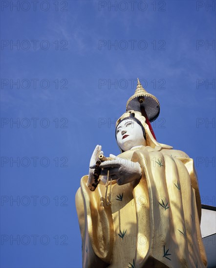 THAILAND, Bangkok, "Wat Ratchasingkhon temple on the banks of the Chao Phraya river.  ‘Guanyin’ Goddess of Mercy statue, the bodhisattva of compassion as venerated by East Asian Buddhists usually depicted as a female figure."