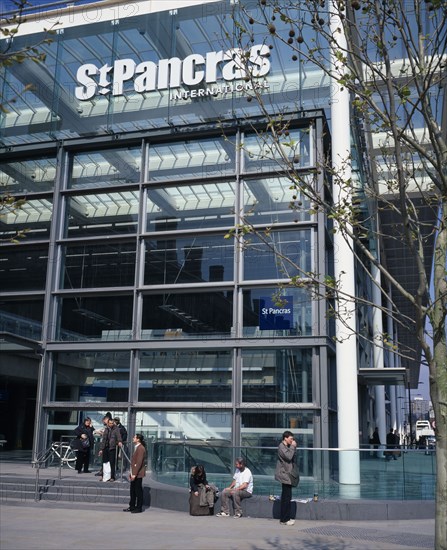 ENGLAND, London, St Pancras , St Pancras International exterior.  New security sealed terminal for Eurostar trains to continental Europe with passengers waiting on steps in the sunshine outside