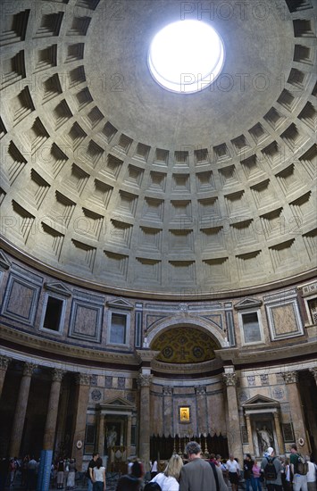 ITALY, Lazio, Rome, The interior with tourists and dome of the Pantheon the Roman temple of all the gods designed and built by Emperor Hadrian converted into a Christian church in the Middle Ages