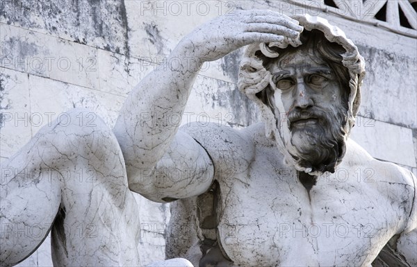 ITALY, Lazio, Rome, Detail of a fountain representing the Adriatic Sea in Brescian marble on the Victor Emmanuel Monument of a statue of a man shading his eyes from the sun