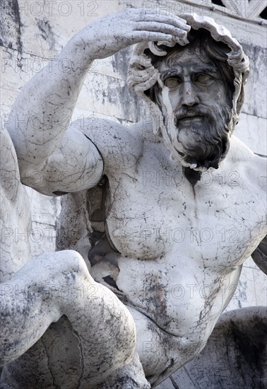 ITALY, Lazio, Rome, Detail of a fountain representing the Adriatic Sea in Brescian marble on the Victor Emmanuel Monument of a statue of a man shading his eyes from the sun