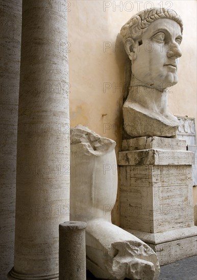 ITALY, Lazio, Rome, Palazzo Dei Conservatore courtyard part of the Capitoline Museums with a giant marble head and arm from an ancient 4th Century colossus statue of Emperor Constantine I