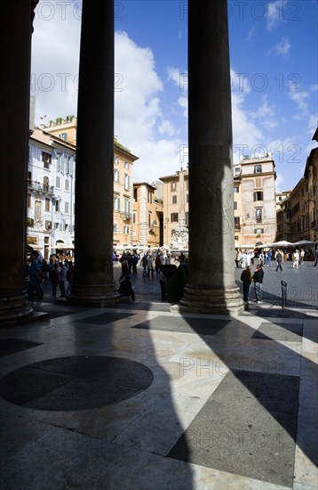 ITALY, Lazio, Rome, Piazza della Rotonda seen through the granite columns of the Pantheon with tourists walking in the square