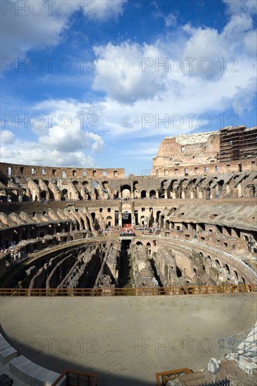 ITALY, Lazio, Rome, The Colosseum amphitheatre interior with tourists built by Emperor Vespasian in AD 80 in the grounds of Domus Aurea the home of Emperor Nero showing the restored sections in the foreground