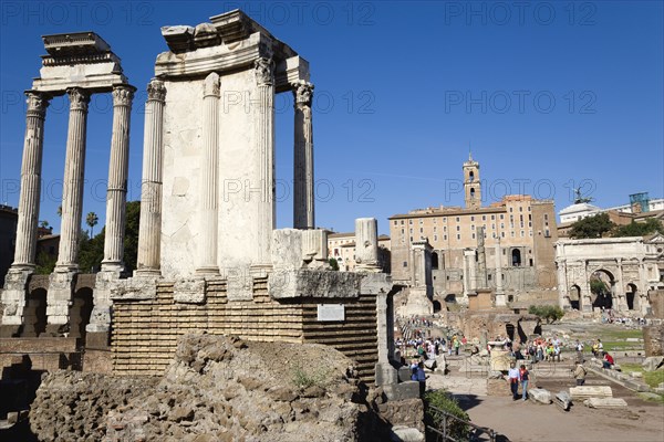 ITALY, Lazio, Rome, The Forum with tourists. The Temple of The Vestals on the left and the Arch of Septimius Severus on the right