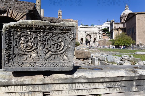 ITALY, Lazio, Rome, The Forum with tourists. Details of ruin fragments with the Arch of Septimius Severus in the centre