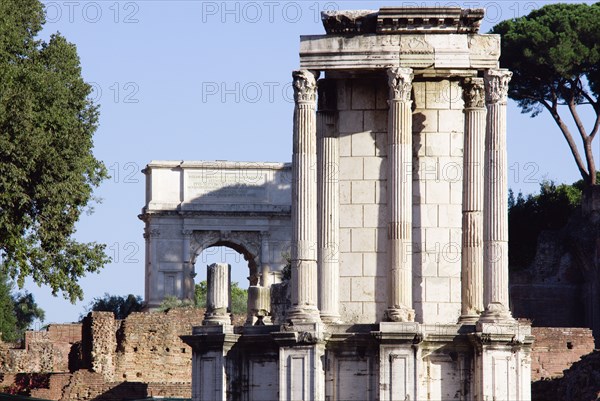 ITALY, Lazio, Rome, The Temple of Vesta in the Forum with the Arch of Titus in the distance