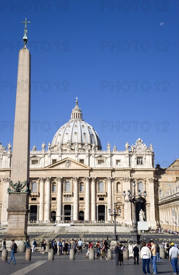 ITALY, Lazio, Rome, Vatican City The Basilica of St Peter and the Piazza San Pietro with tourists in the square beside the Obelisk