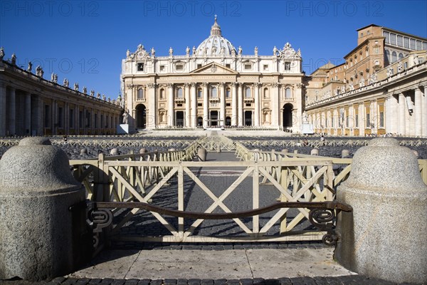 ITALY, Lazio, Rome, Vatican City The Basilica of St Peter with tourists at the entrance and empty seating for the Papal audience in the Piazza San Pietro