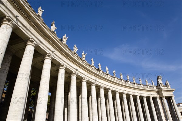 ITALY, Lazio, Rome, Vatican City The sweeping colonnade by Bernini topped with statues that circles Piazza San Pietro or St Peter's Square