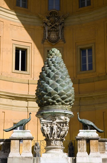 ITALY, Lazio, Rome, Vatican City Museums The Cortille della Pigna a huge bronze pine cone from a Roman fountain in a niche below the Papal heraldic crest in a niche by Pirro Ligorio on the Belvedere Palace