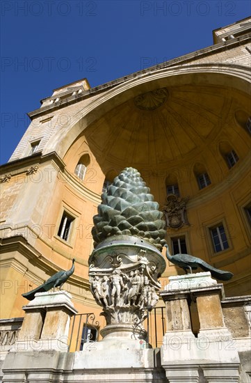 ITALY, Lazio, Rome, Vatican City Museums The Cortille della Pigna a huge bronze pine cone from a Roman fountain in a niche below the Papal heraldic crest in a niche by Pirro Ligorio on the Belvedere Palace