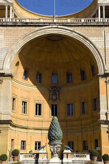 ITALY, Lazio, Rome, Vatican City Museums The Cortille della Pigna a huge bronze pine cone from a Roman fountain in a niche below the Papal heraldic crest in a niche by Pirro Ligorio on the Belvedere Palace