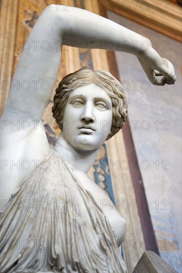 ITALY, Lazio, Rome, Vatican City Museums A statue of a woman raising her arm in the Room of The Busts in the Belvedere Palace