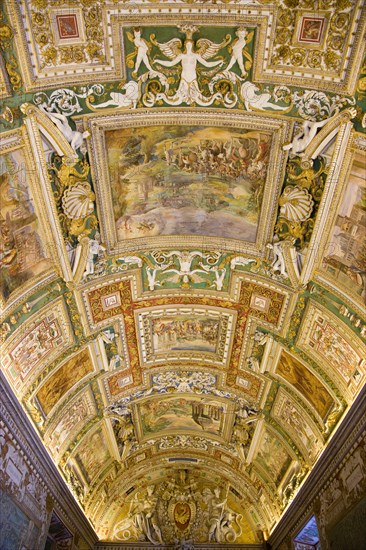 ITALY, Lazio, Rome, Vatican City Museums The highly decorated illuminated ceiling of the Gallery of Maps