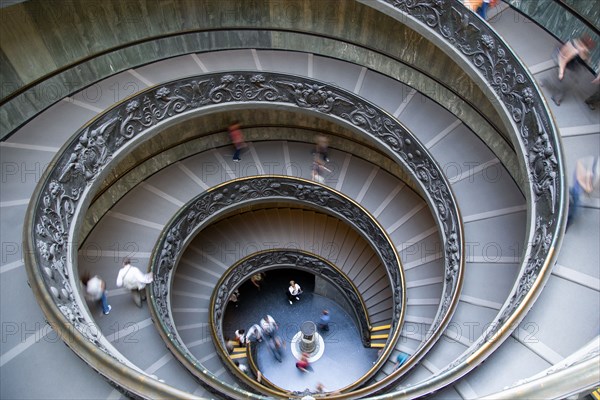 ITALY, Lazio, Rome, Vatican City Museums Tourists descending the Spiral Ramp designed by Giuseppe Momo in 1932 leading from the museums to the street level below