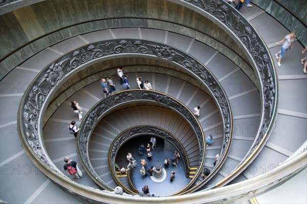 ITALY, Lazio, Rome, Vatican City Museums Tourists descending the Spiral Ramp designed by Giuseppe Momo in 1932 leading from the museums to the street level below