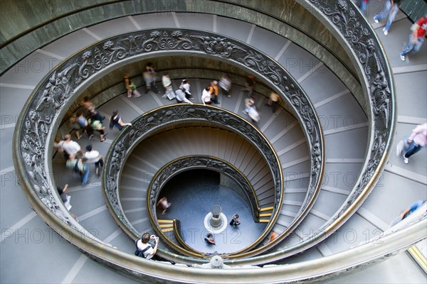 ITALY, Lazio, Rome, Vatican City Museums Tourists descending the Spiral Ramp designed by Giuseppe Momo in 1932 leading from the museums to the street level below