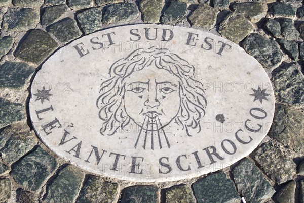 ITALY, Lazio, Rome, Vatican City Plaque in the pavement of Piazza San Pietro or St Peter's Square depicting the East South East wind know as the Levante Scirocco