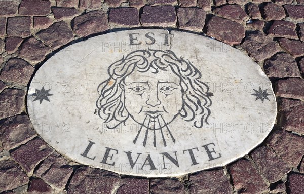 ITALY, Lazio, Rome, Vatican City Plaque in the pavement of Piazza San Pietro or St Peter's Square depicting the East wind know as the Levante