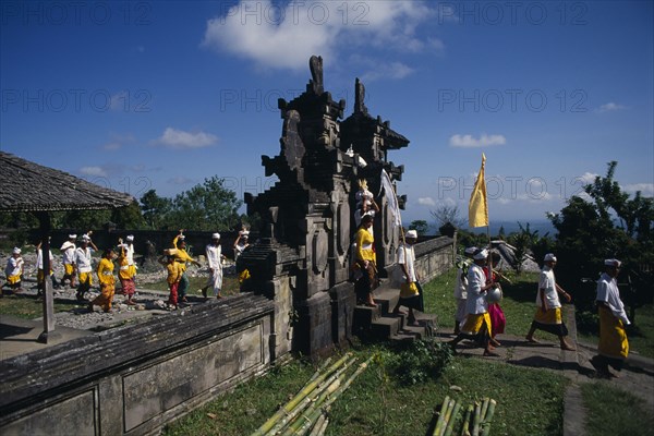 INDONESIA, Bali, Besakih Temple, Procession of mourners leaving cremation ceremony in temple grounds. Besakih temple is situated on Mount Agung and known as the ‘Mother Temple of Bali.’