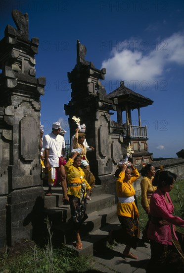 INDONESIA, Bali, Besakih Temple, Procession of mourners leaving cremation ceremony in temple grounds.  Besakih temple is situated on Mount Agung and known as the ‘Mother Temple of Bali.’