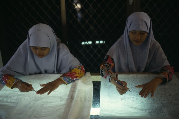 MALAYSIA, Crafts, Young women tracing floral patterns first on to paper then transferring them to silk or satin.