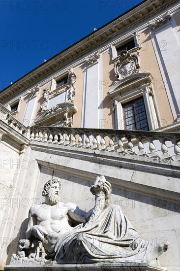 ITALY, Lazio, Rome, Palazzo Senatorio on the Capitol with a staircase by Michelangelo and a statue representing the River Tiber from Hadrian's baths on the Quirinal