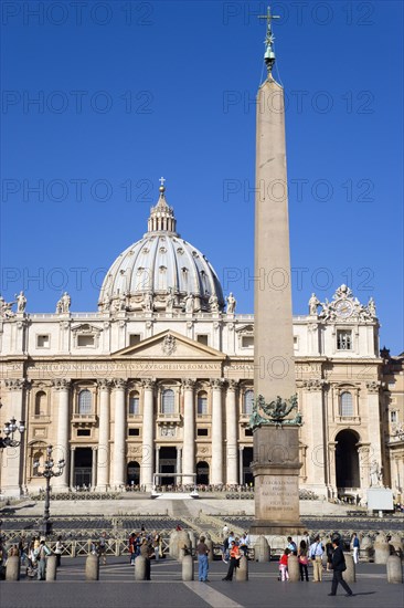 ITALY, Lazio, Rome, Vatican City St Peters Square with tourists and the facade of St Peters Basilica beyond the obelisk
