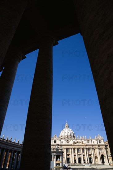 ITALY, Lazio, Rome, Vatican City The Basilica of St Peter seen through the pillars of the Ccolonnade by Bernini