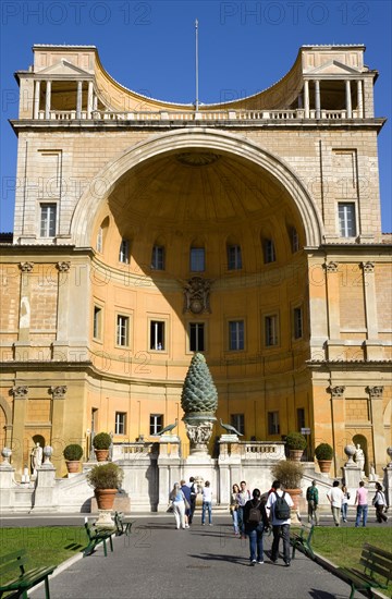 ITALY, Lazio, Rome, Vatican City Museum The central niche designed by Pirro Ligorio in the Belvedere palace housing the Cortile della Pigna a giant bronze pine cone from an ancient Roman fountain with tourists walking in the courtyard