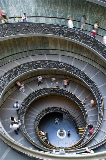 ITALY, Lazio, Rome, Vatican City Museum Tourists walking down the Spiral Ramp designed in 1932 by Giuseppe Momo