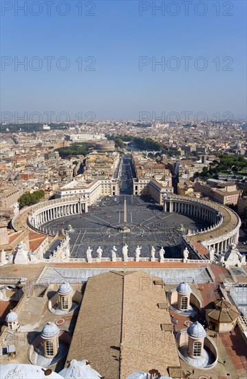 ITALY, Lazio, Rome, Vatican City View from the Dome of St Peter's Basilica over the city towards the River Tiber and Castel Sant Angelo with the Colonnade by Bernini around the Square in the foreground